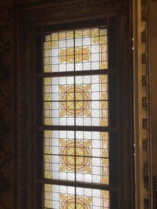 Tall stained glass panel with gold pattern