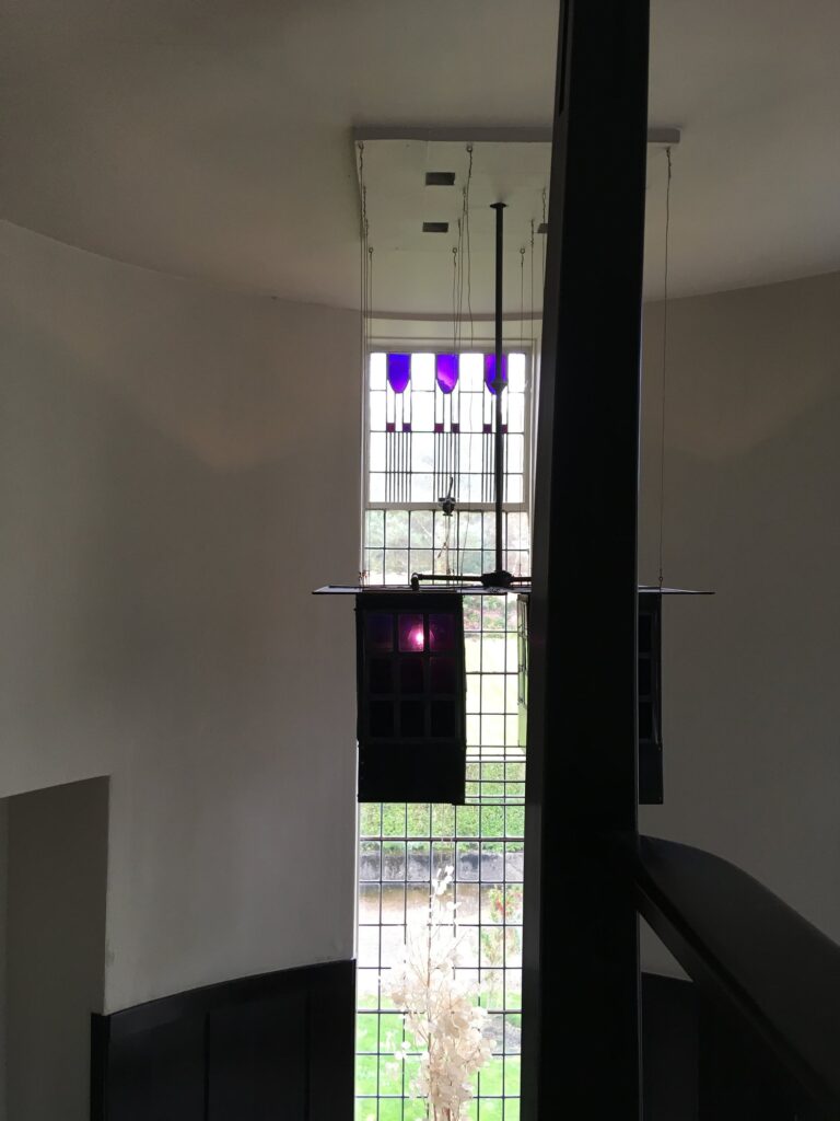 Tall stair window with purple tulip glass