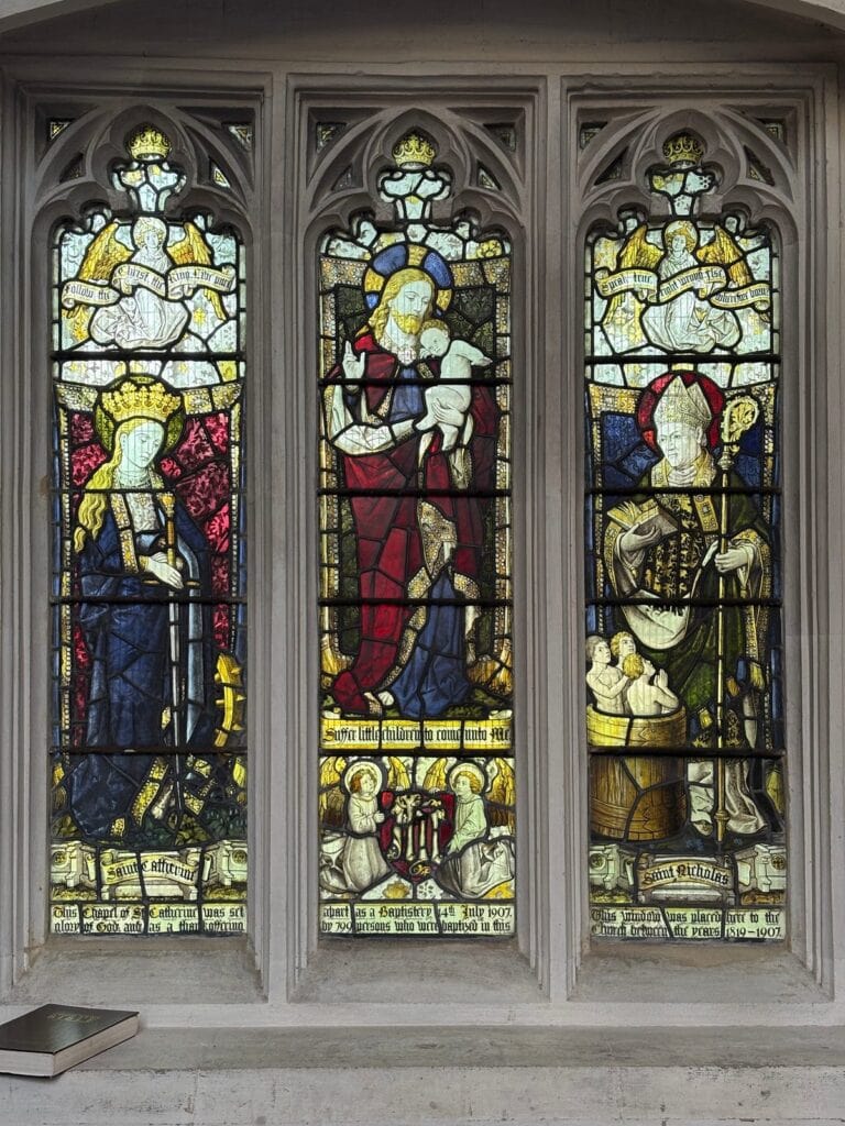 Three-light church window with a crowned figure, Christ and a bishop, Chippenham