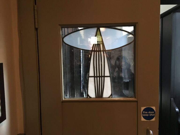 Timber door with leaded glass panel and tulip shape