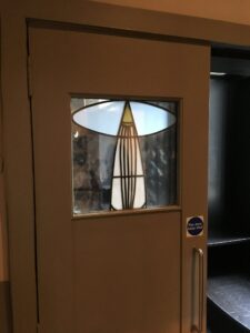 Timber door with leaded glass panel and tulip shape wider view