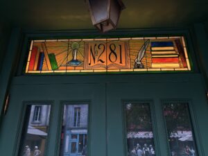 Transom with number 281 books and quill 2