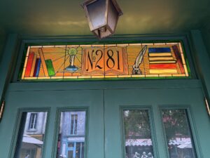 Transom with number 281 books and quill