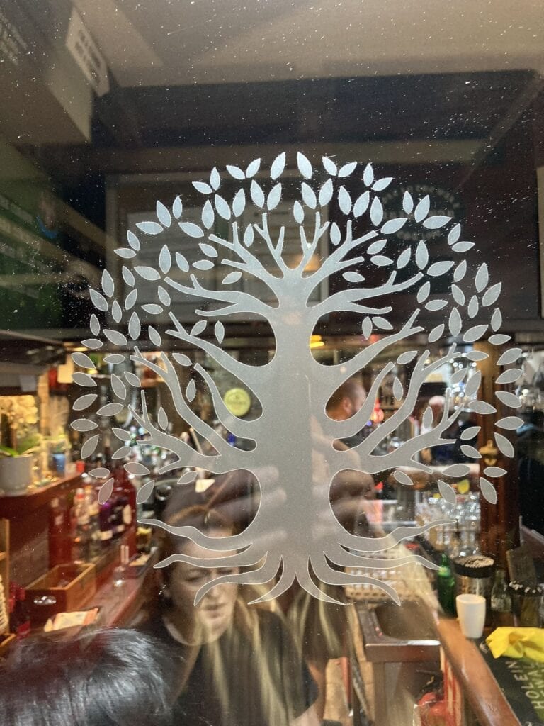 Tree of life etched glass panel in a pub