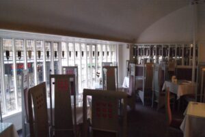 Front saloon of the Willow Tea Rooms with its long leaded windows and tall chairs, photographed in 2013