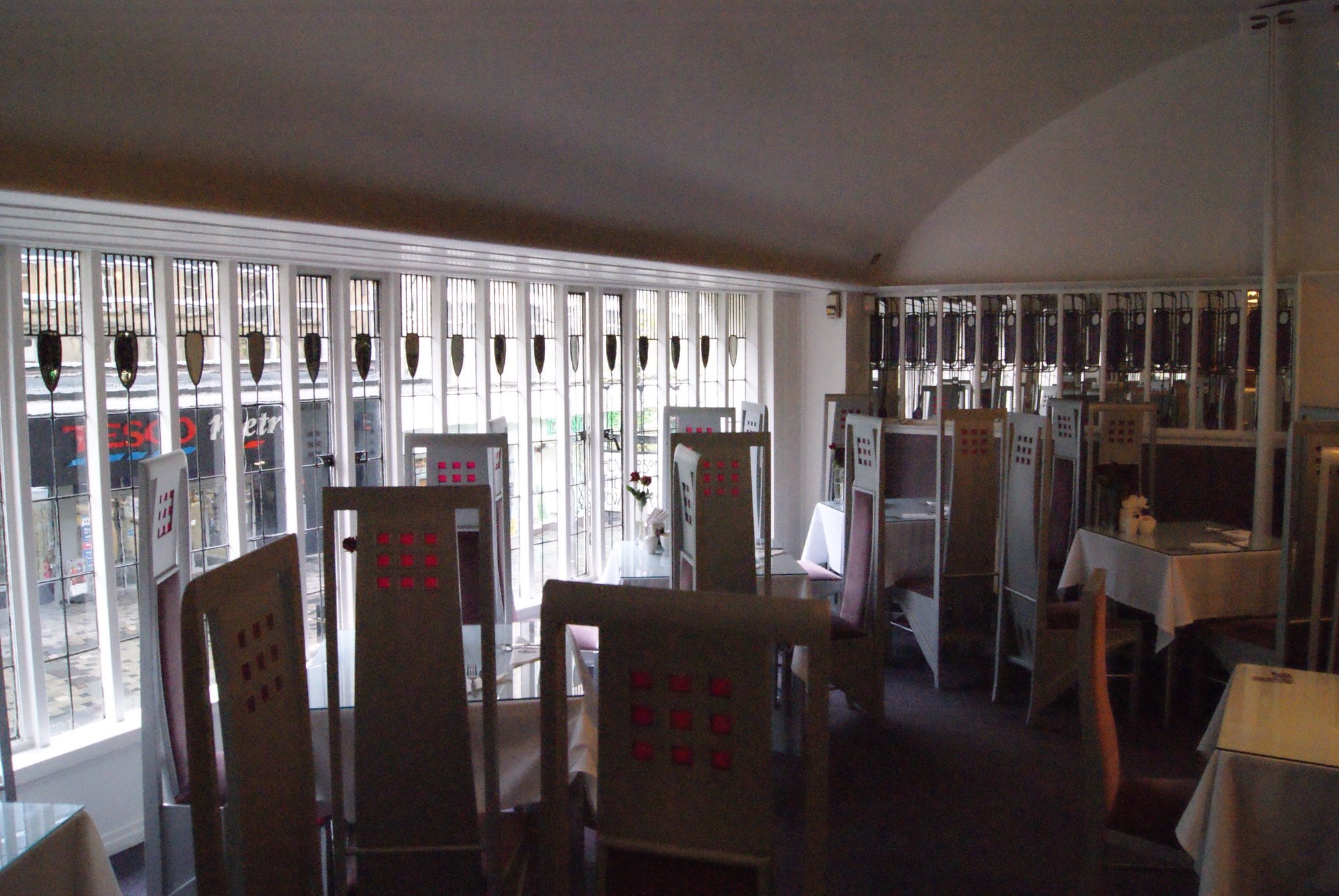 Front saloon of the Willow Tea Rooms with its long leaded windows and tall chairs, photographed in 2013