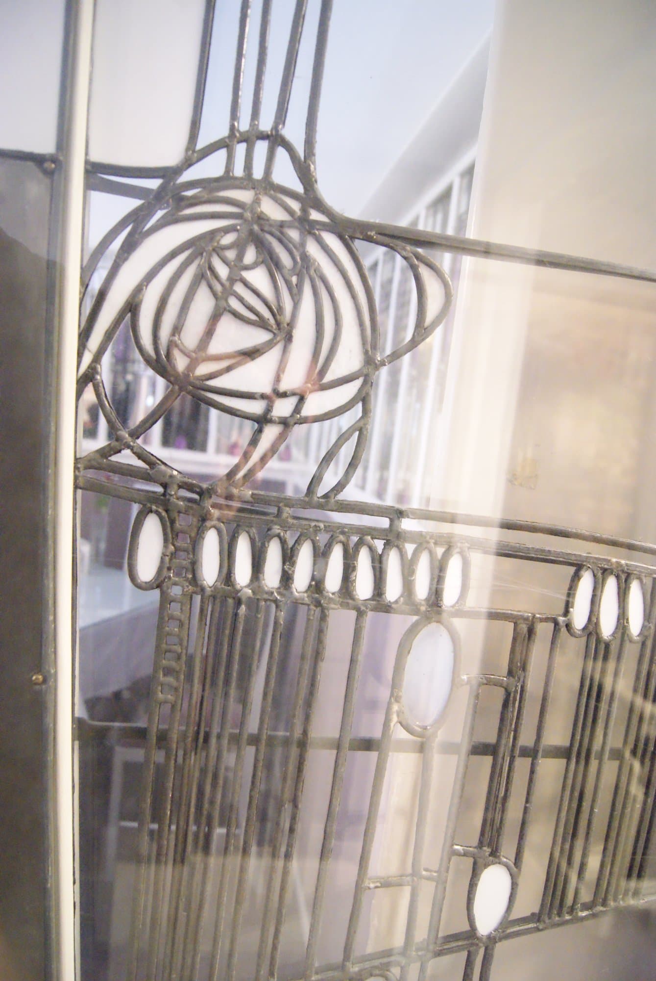 Glazed door with a Mackintosh rose at the Willow Tea Rooms, close view, photographed in 2013