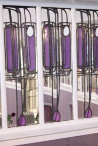 Purple leaded glass panels with tulip shapes at the Willow Tea Rooms, photographed in 2013