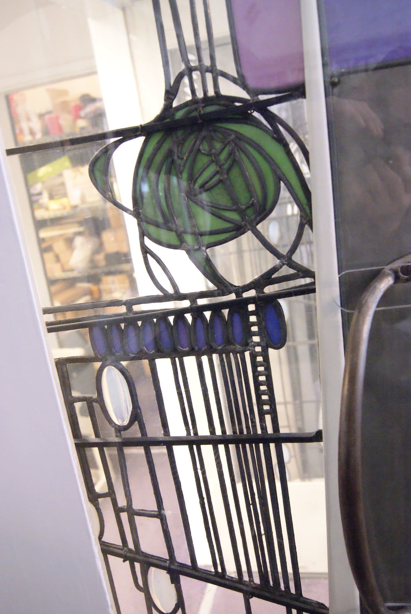 Close view of a Mackintosh rose in green glass at the Willow Tea Rooms, photographed in 2013