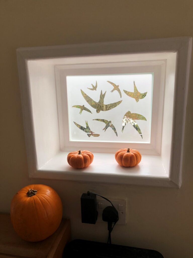 Window with a flock of birds in glass